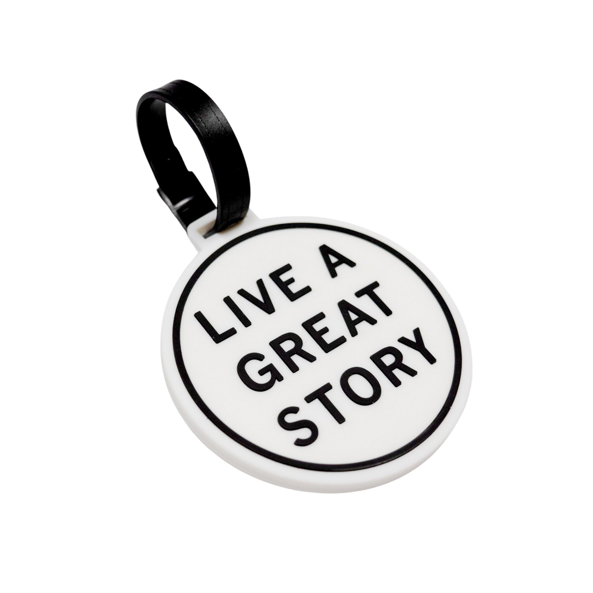 A closeup of a LIVE A GREAT STORY luggage tag