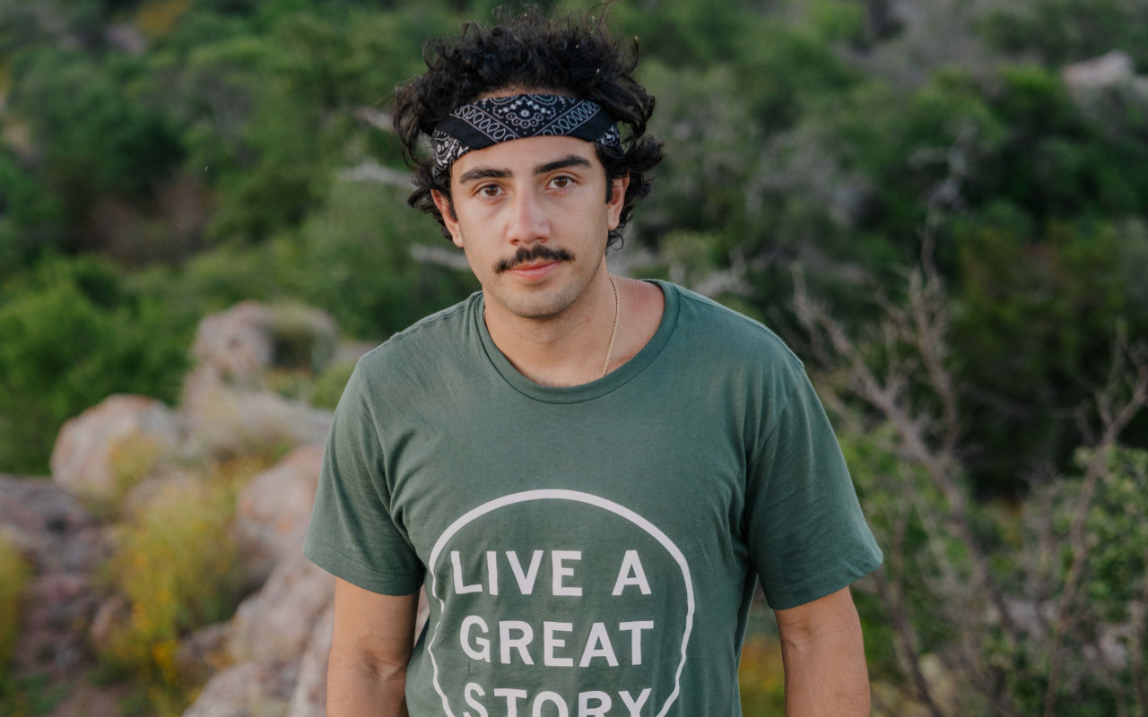 A man wearing a LIVE A GREAT STORY T-shirt