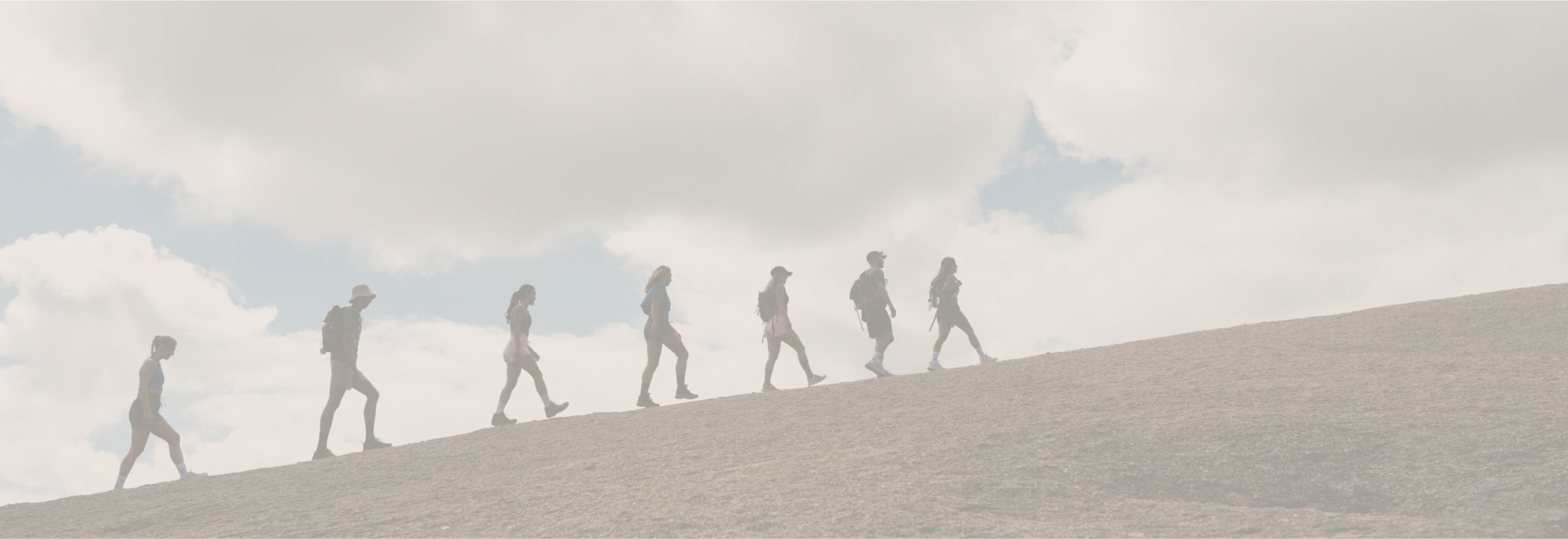 A group of people walking up a hill