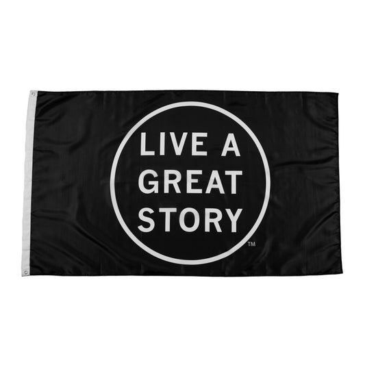 A black LIVE A GREAT STORY Adventure Flag