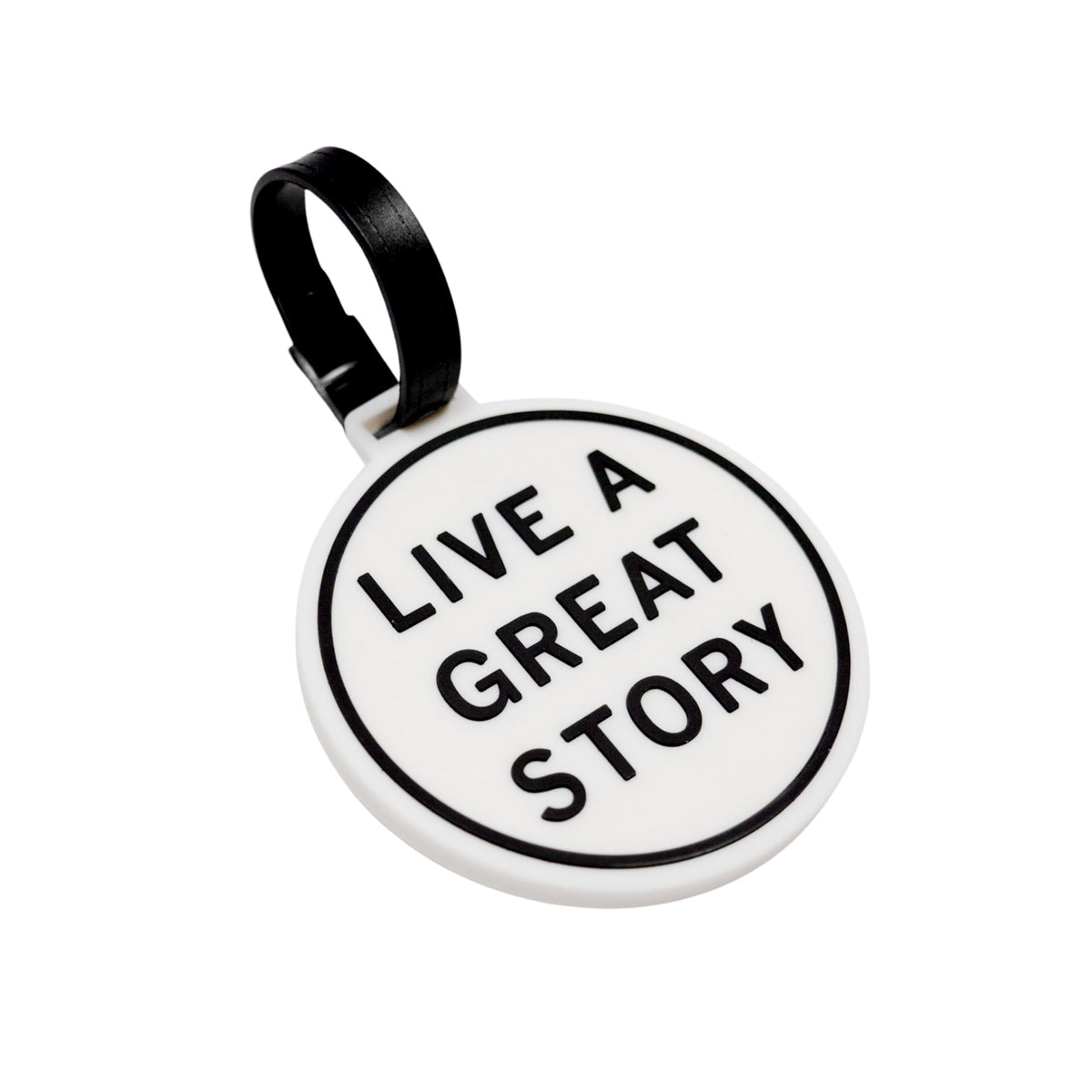 A closeup of a LIVE A GREAT STORY luggage tag