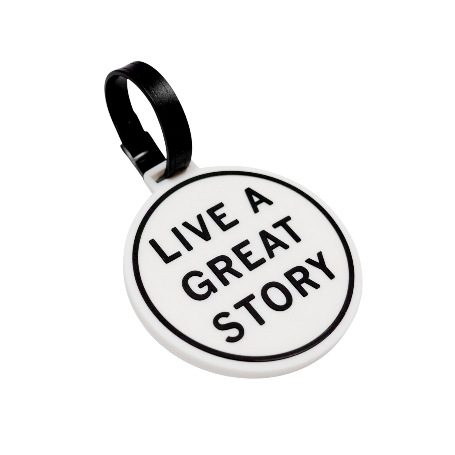 A closeup of a LIVE A GREAT STORY luggage tag