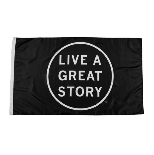 A black LIVE A GREAT STORY Mini Adventure Flag